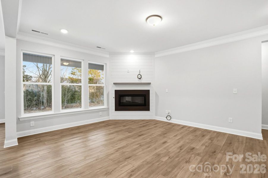 Family Room featuring Shiplap surround cosmo gas fireplace option