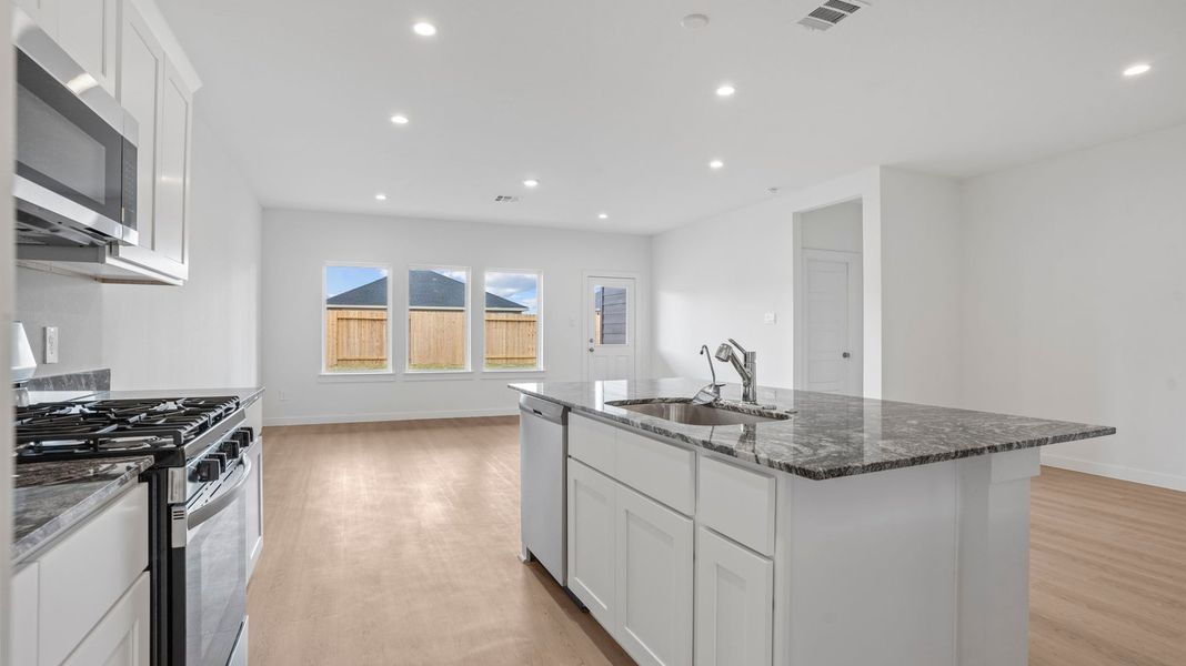 Representative furnished interior of a home built from the Mitchell by D.R. Horton in Caldwell Crossing, Iowa Colony (Image 7).