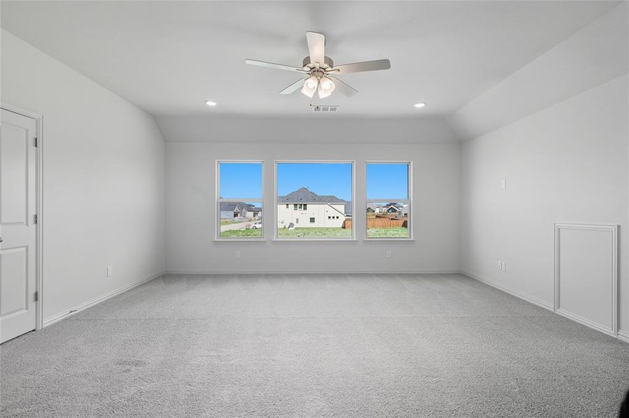 Spare room featuring ceiling fan, light colored carpet, vaulted ceiling, and recessed lighting Spare room featuring ceiling fan, light colored carpet, vaulted ceiling, and recessed lighting