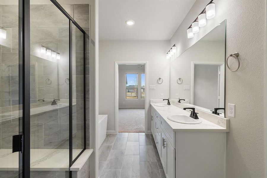 Your beautiful owner's bath features a spacious walk in shower and free standing tub that create a spa like experience every day!