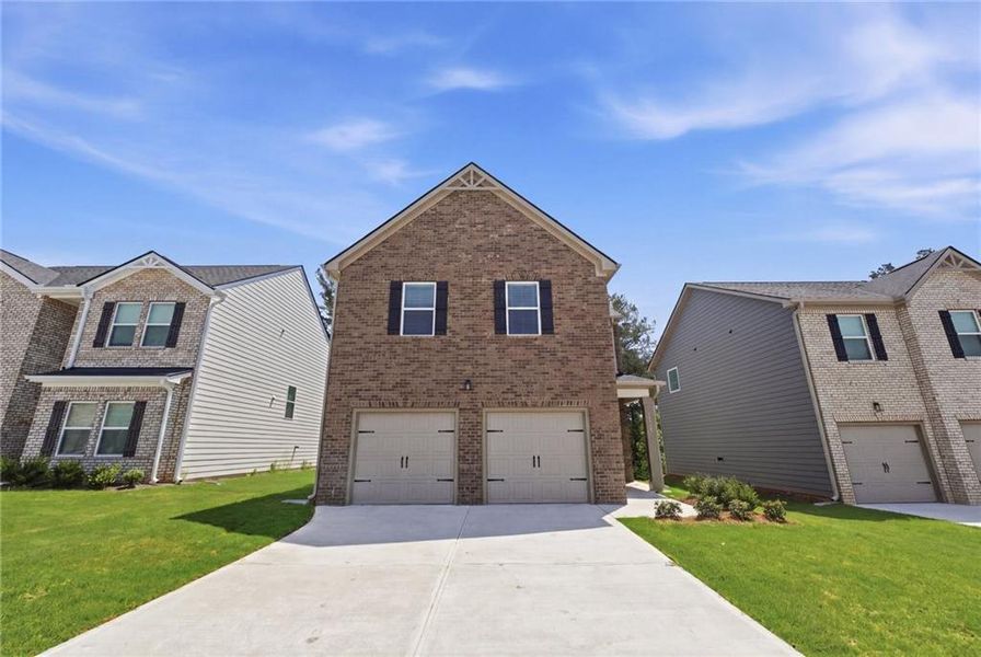 Front exterior of a new home in Creekbend Overlook, South Fulton, GA, highlighting curb appeal (Image 2). Front exterior of a new home in Creekbend Overlook, South Fulton, GA, highlighting curb appeal (Image 2).