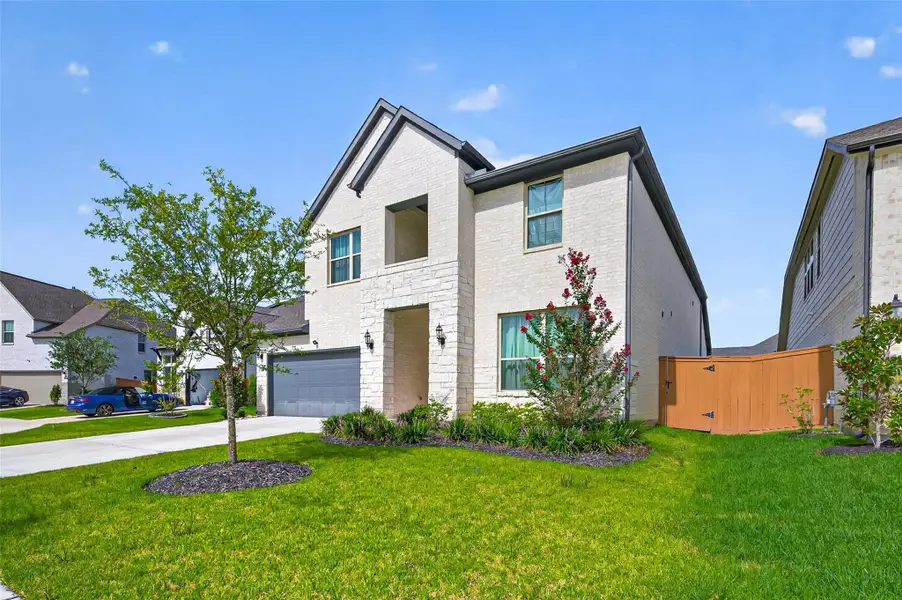 Front exterior of a new home in Sunterra, Katy, TX, highlighting curb appeal (Image 2). Front exterior of a new home in Sunterra, Katy, TX, highlighting curb appeal (Image 2).