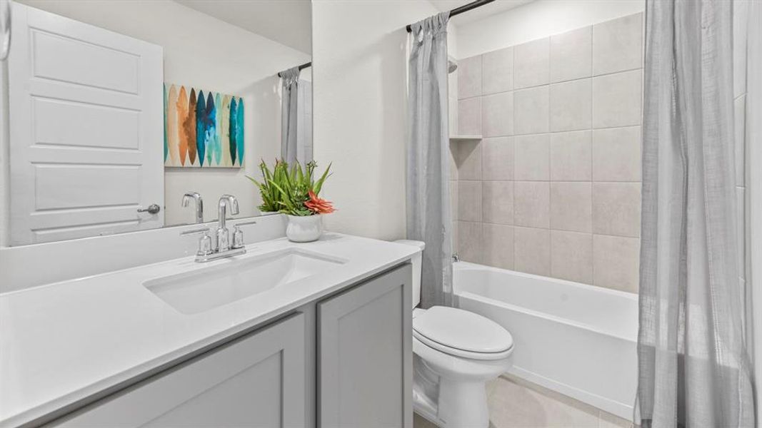 Bathroom featuring a single vanity with light gray cabinetry, an integrated sink, and a chrome faucet