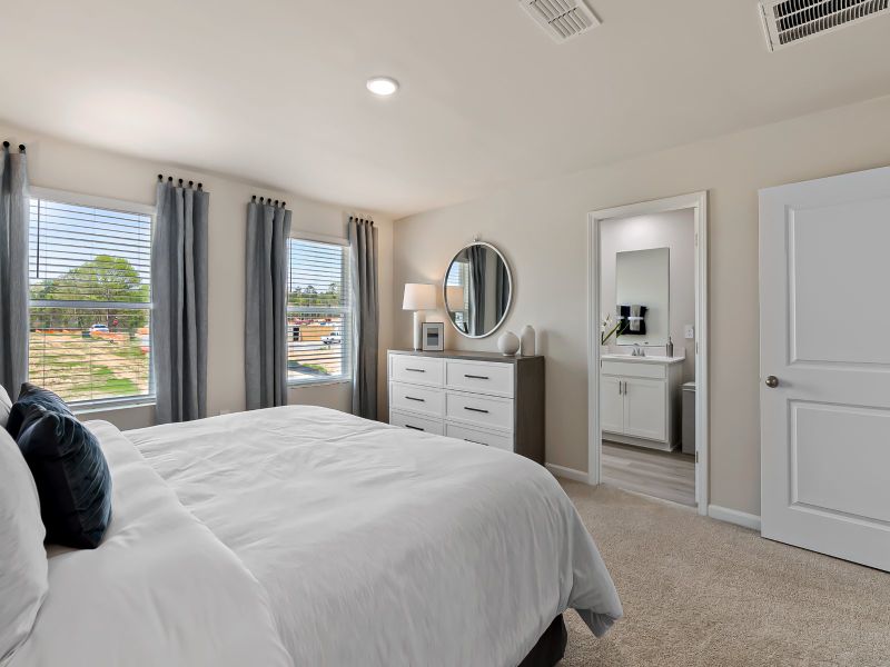 The large primary suite features an ensuite bath with dual sinks and a spacious walk-in closet.