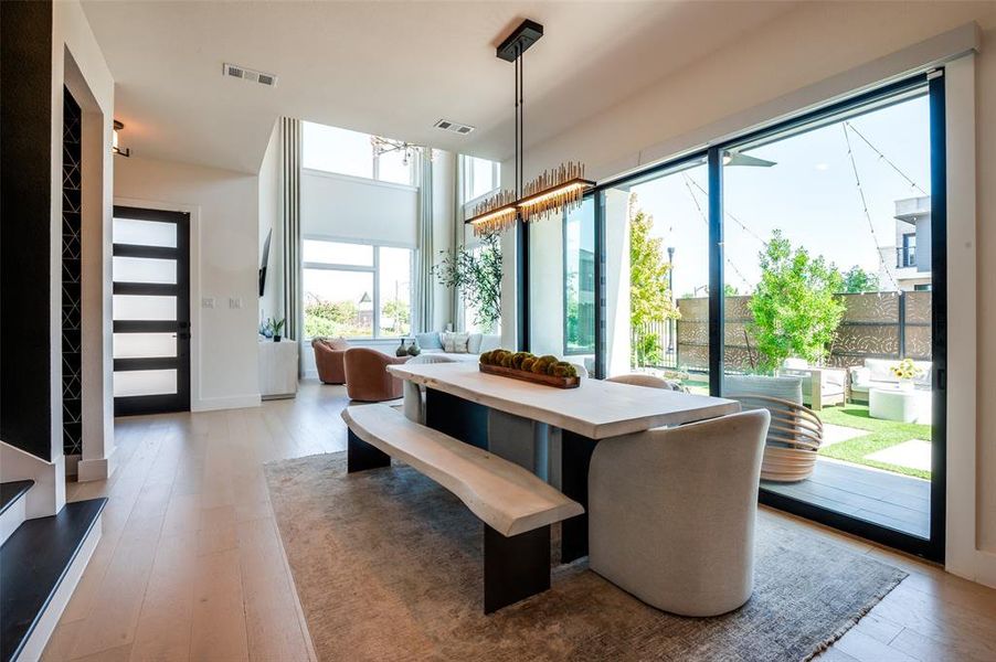 Photo of dining and living room areas.  Sliding glass doors brings the outdoors inside.