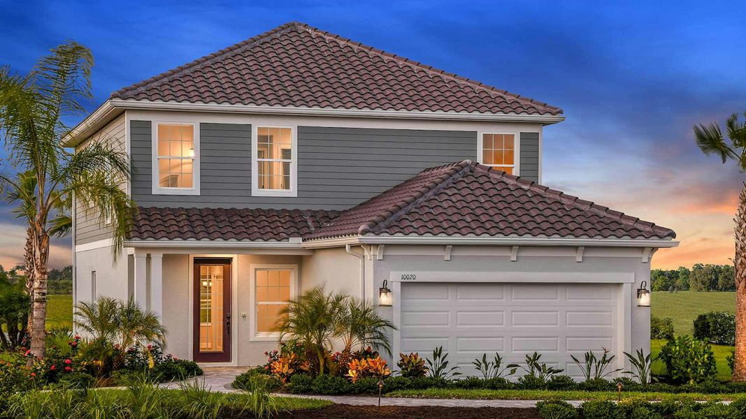 Front exterior of a new home in Grand Park Real Estate and Homes for Sale in Sarasota, FL - Neal Communities, Sarasota, FL, highlighting curb appeal (Image 23).