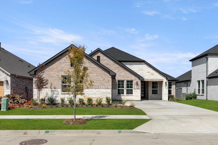 Front exterior of a new home in Inspiration Collection at Union Park, Little Elm, TX, highlighting curb appeal (Image 1).