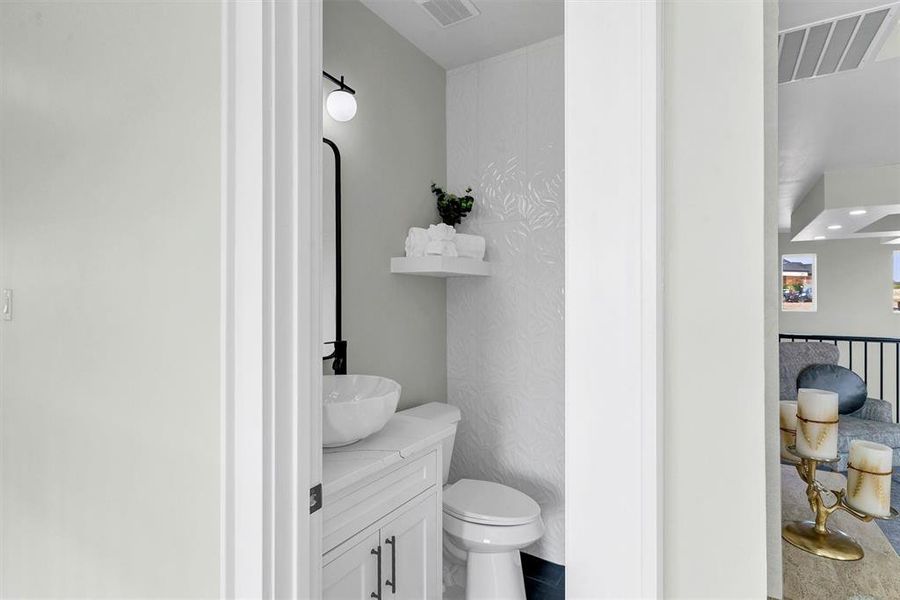 Bathroom featuring vanity and toilet