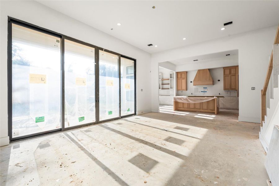 Living room opens to the covered patio through these beautiful, oversized metal sliding doors. Gas fireplace with custom built shelving. Living room opens to the covered patio through these beautiful, oversized metal sliding doors. Gas fireplace with custom built shelving.
