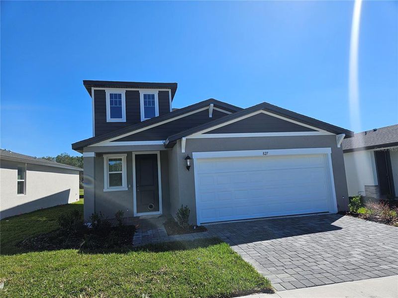 Front exterior of a new home in The Reserve at Hammock Oaks - Classic Series, Lady Lake, FL, highlighting curb appeal (Image 2).