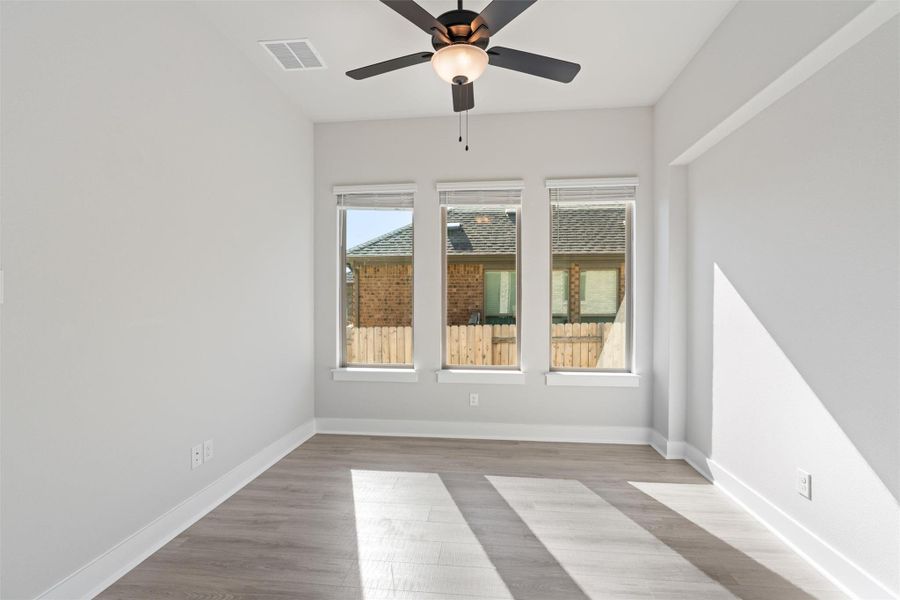Spare room featuring light wood-style floors and ceiling fan