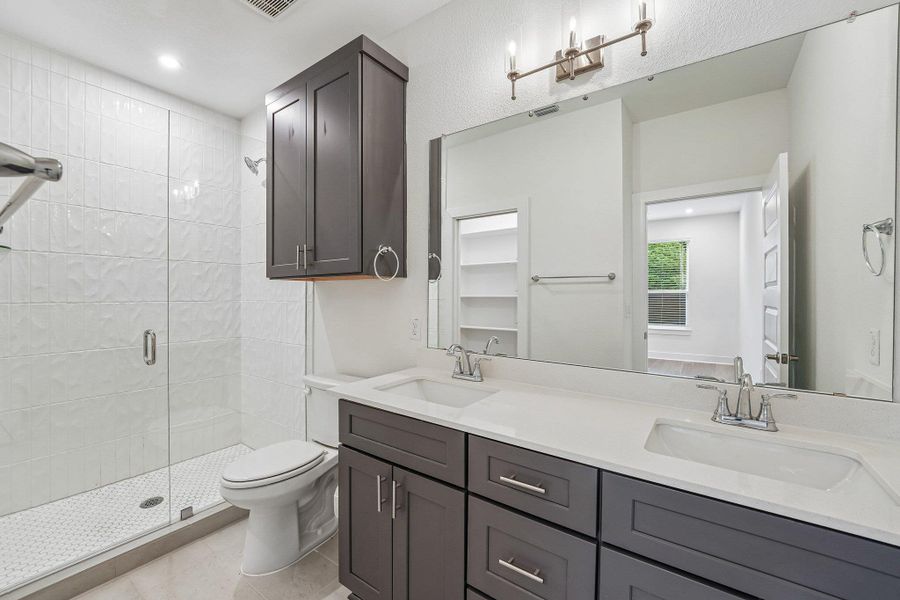 The primary ensuite features adual quartz vanity and And an oversized walk in showerwith subway tile surround, enclosed by frameless glass. The primary ensuite features adual quartz vanity and And an oversized walk in showerwith subway tile surround, enclosed by frameless glass.