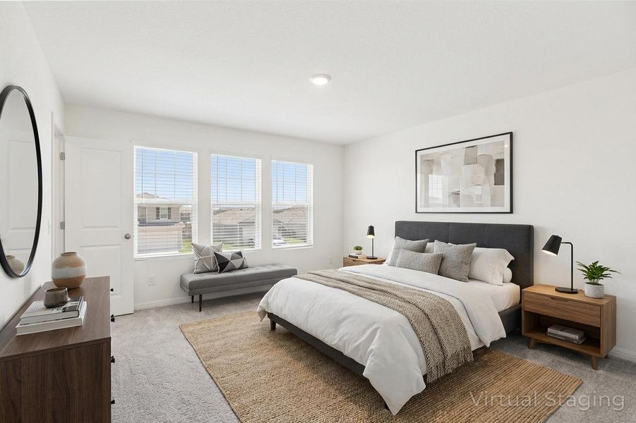 Bedroom featuring light colored carpet and baseboards