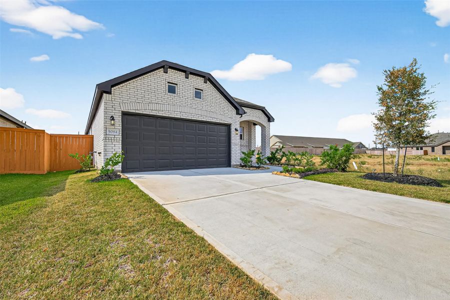 Front exterior of a new home in Sunterra, Katy, TX, highlighting curb appeal (Image 2). Front exterior of a new home in Sunterra, Katy, TX, highlighting curb appeal (Image 2).