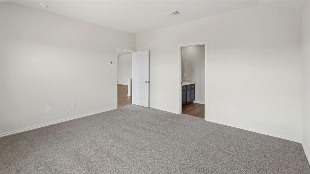 Spacious room featuring light gray carpeting and white painted walls