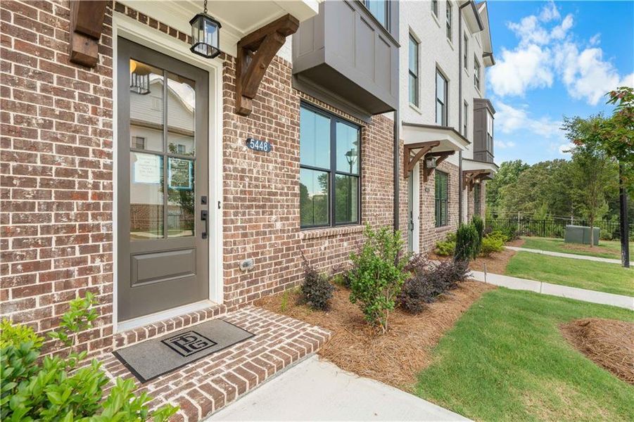 Exterior details and patio area of a home in Millcroft Townhomes, Buford (Image 1).