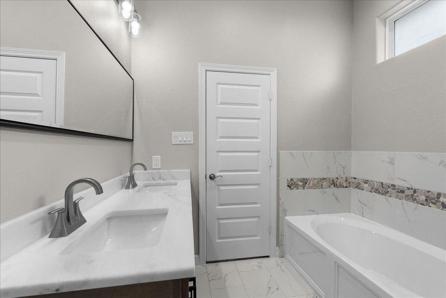 Another view of the master bathroom, door opens to bedroom.