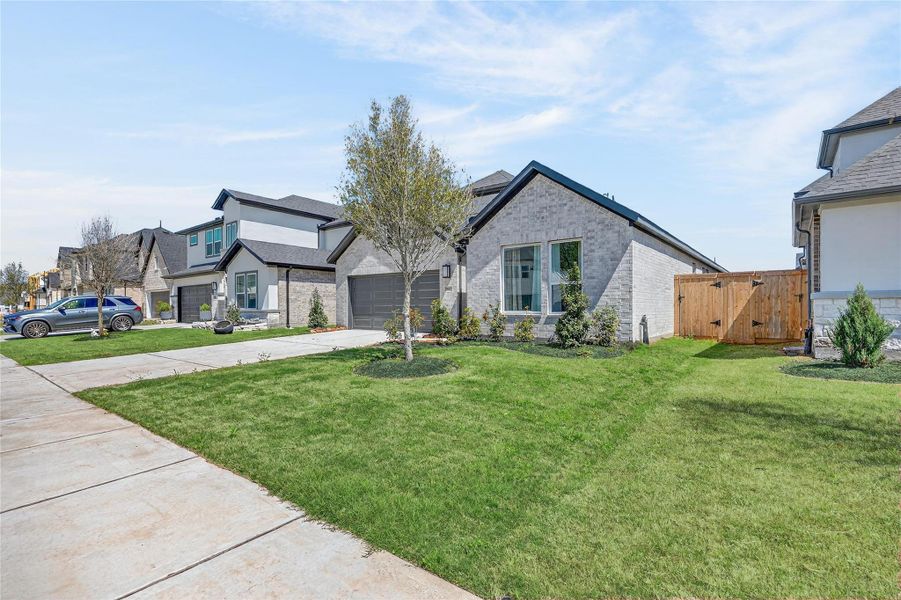 Front exterior of a new home in Trillium, Richmond, TX, highlighting curb appeal (Image 25).