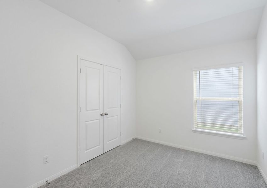 Bedroom with lush carpet flooring Bedroom with lush carpet flooring