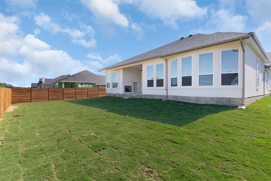 Rear view of house featuring a patio area, a fenced backyard, and ceiling fan