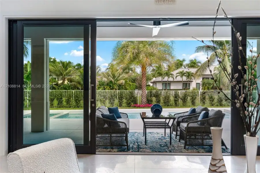 Large-format sliding glass doors, covered concrete patio, built-in ceiling fan, swimming pool, and privacy fencing Large-format sliding glass doors, covered concrete patio, built-in ceiling fan, swimming pool, and privacy fencing