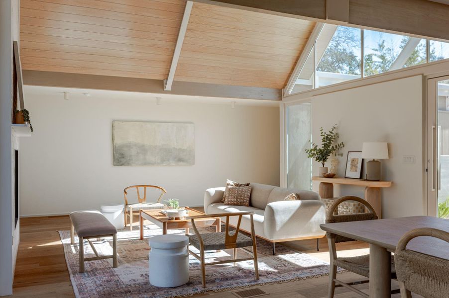 Sitting room featuring a high wooden beamed ceiling and light wood-type flooring