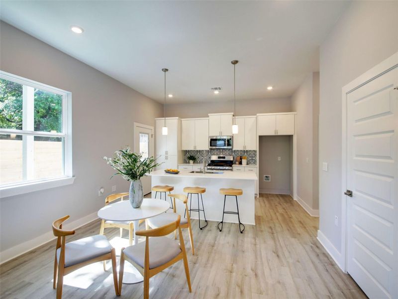 Dining room featuring light wood-type flooring and recessed lighting