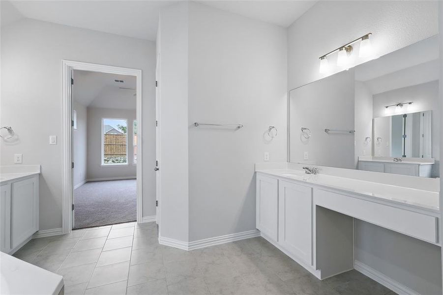 Bathroom with vanity and baseboards Bathroom with vanity and baseboards