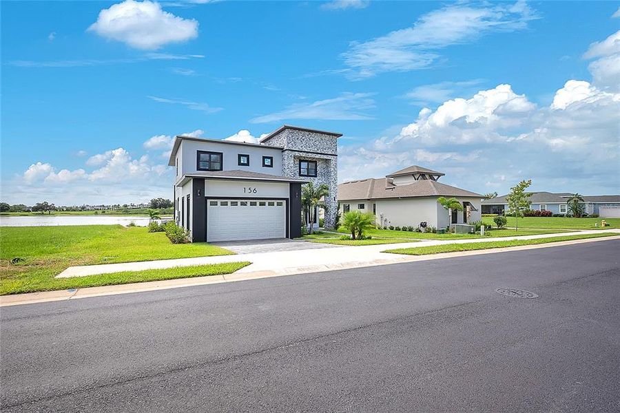 Front exterior of a new home in , Lake Alfred, FL, highlighting curb appeal (Image 31).