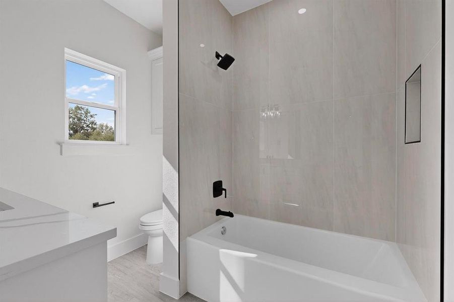 Bathroom with vanity, bathtub / shower combination, and light wood-style floors