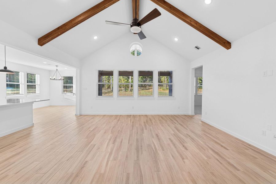 High vaulted ceilings with stained beams in the great room (*Photo not of actual home and used for illustration purposes only.)