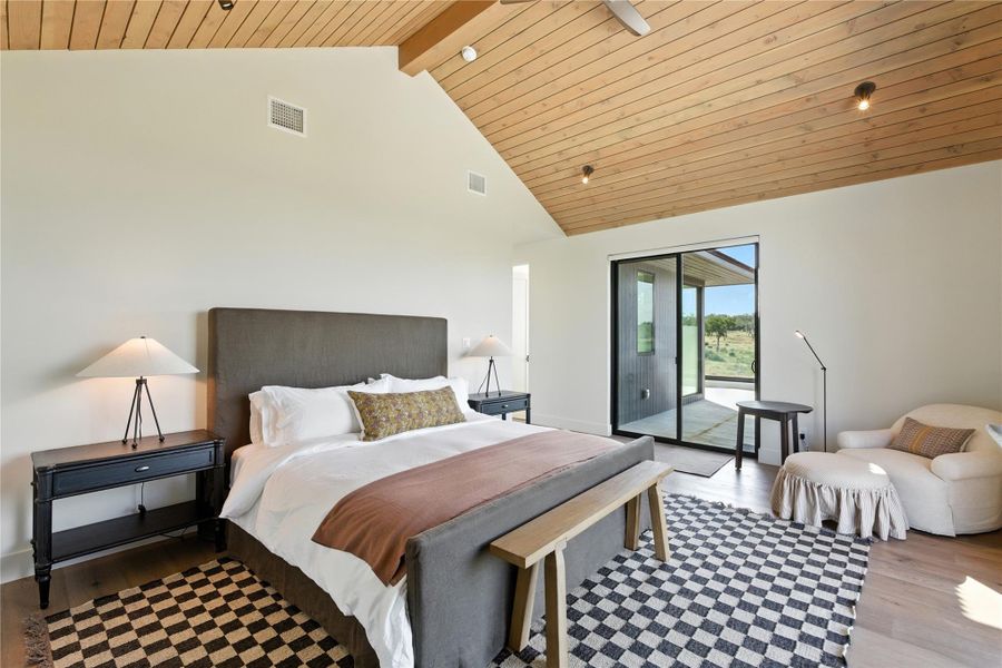 Bedroom featuring high vaulted ceiling, light wood-type flooring, access to outside, and a wood ceiling with exposed beams