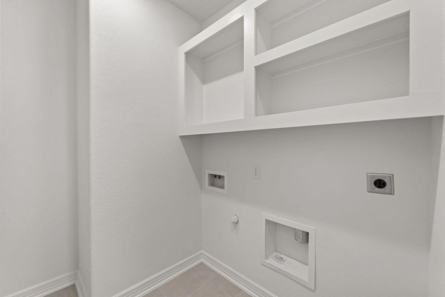 The laundry room layout is carefully planned for optimal workflow with designated areas for washing, drying, and storing.