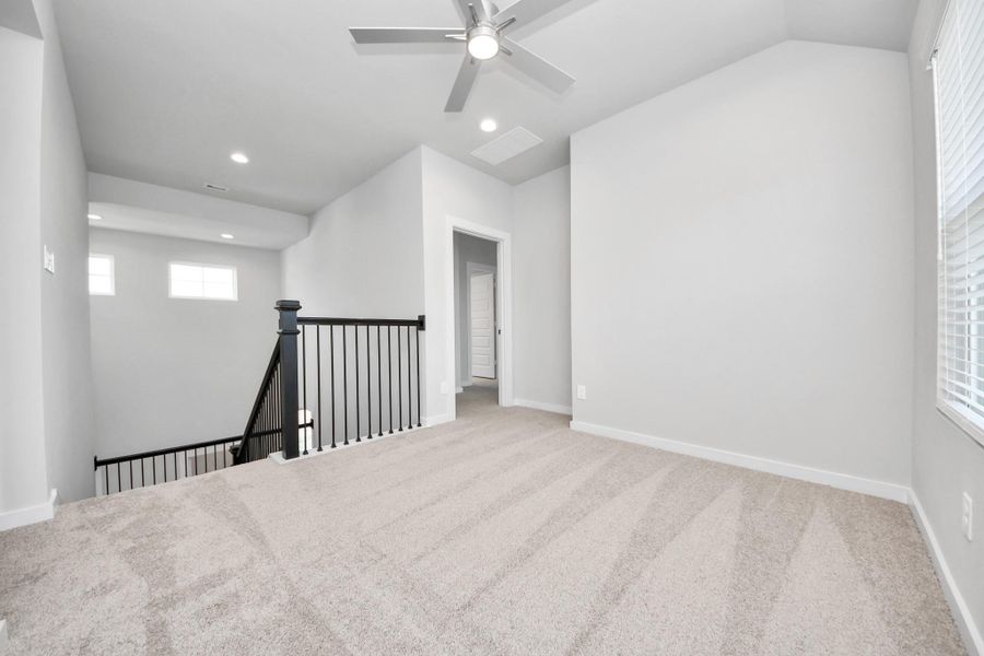 Come upstairs and enjoy a day of leisure in this fabulous game room! This is the perfect hangout spot or adult game room! Features plush carpet, high ceilings, custom paint and windows for plenty of natural light. Sample photo of completed home with similar floor plan. Actual colors and selections may vary. Come upstairs and enjoy a day of leisure in this fabulous game room! This is the perfect hangout spot or adult game room! Features plush carpet, high ceilings, custom paint and windows for plenty of natural light. Sample photo of completed home with similar floor plan. Actual colors and selections may vary.