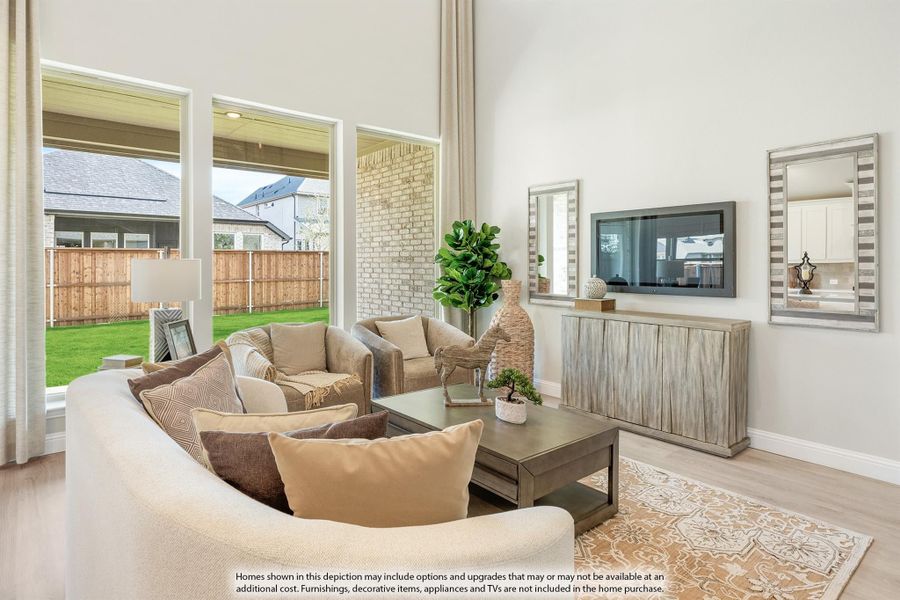 Bright living room with high ceilings, large windows, neutral sofas, wall-mounted TV, and backyard view. Bright living room with high ceilings, large windows, neutral sofas, wall-mounted TV, and backyard view.
