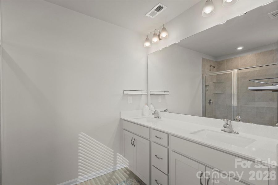 Dual vanities with lots of light and large square sinks. Dual vanities with lots of light and large square sinks.