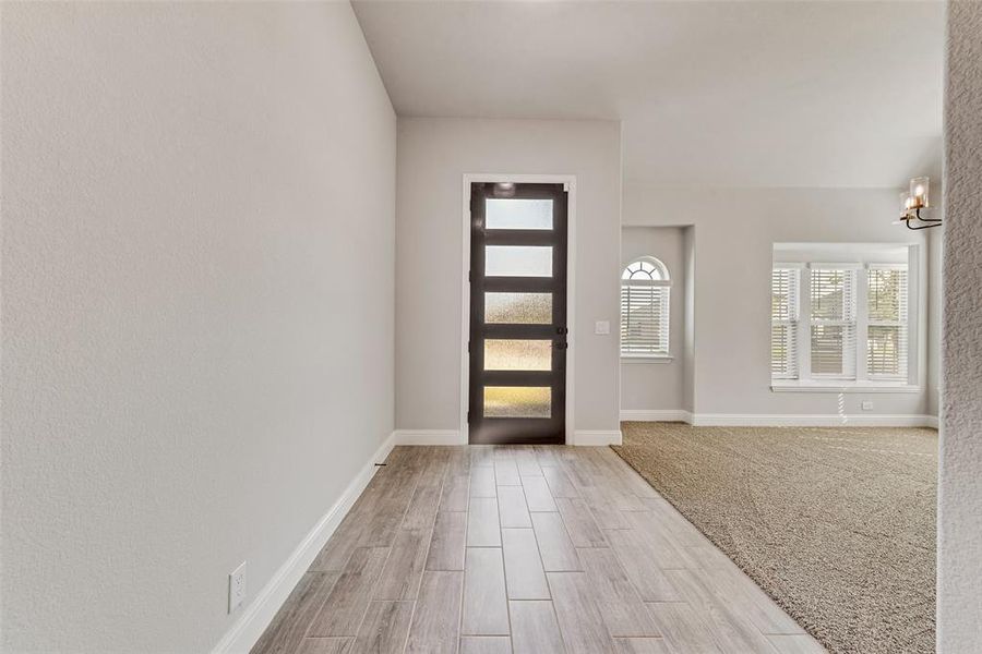 Entrance foyer featuring wood tiled floors and baseboards Entrance foyer featuring wood tiled floors and baseboards
