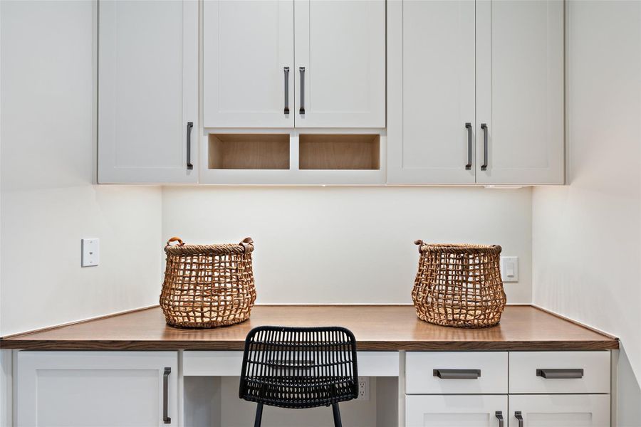 Home office featuring built in desk