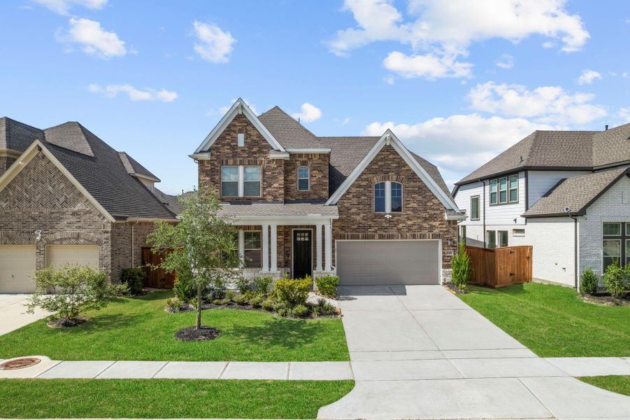 Front exterior of a new home in Towne Lake 50', Cypress, TX, highlighting curb appeal (Image 21).