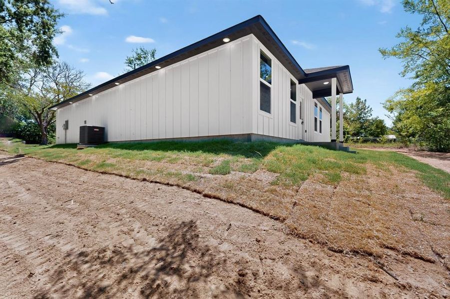 Modern exterior featuring white vertical siding and dark trim