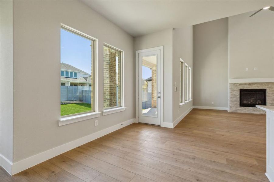 Unfurnished living room with a fireplace and light hardwood / wood-style flooring