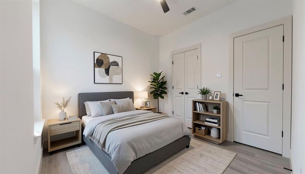 Bedroom with light wood finished floors, ceiling fan, and a closet