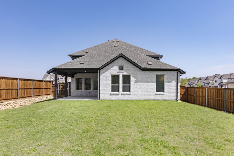 Exterior details and patio area of a home in The Reserve at Spiritas Ranch, Little Elm (Image 4). Exterior details and patio area of a home in The Reserve at Spiritas Ranch, Little Elm (Image 4).