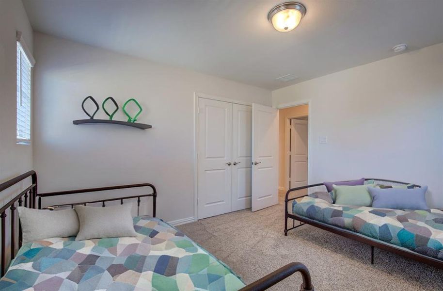 Carpeted bedroom with a closet