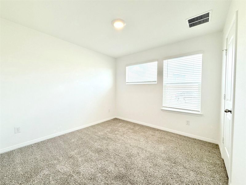 Carpeted spare room featuring baseboards Carpeted spare room featuring baseboards