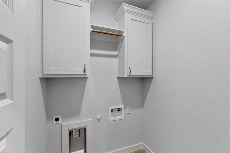 Laundry area featuring hookup for a gas dryer, hookup for a washing machine, and cabinet space Laundry area featuring hookup for a gas dryer, hookup for a washing machine, and cabinet space