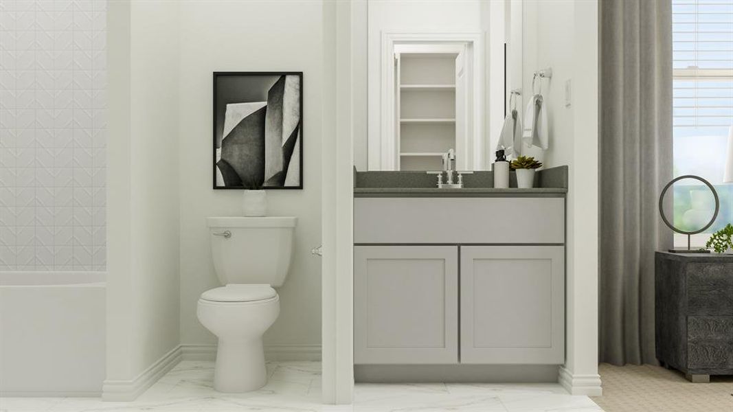 Bathroom featuring vanity, tile patterned flooring, and toilet