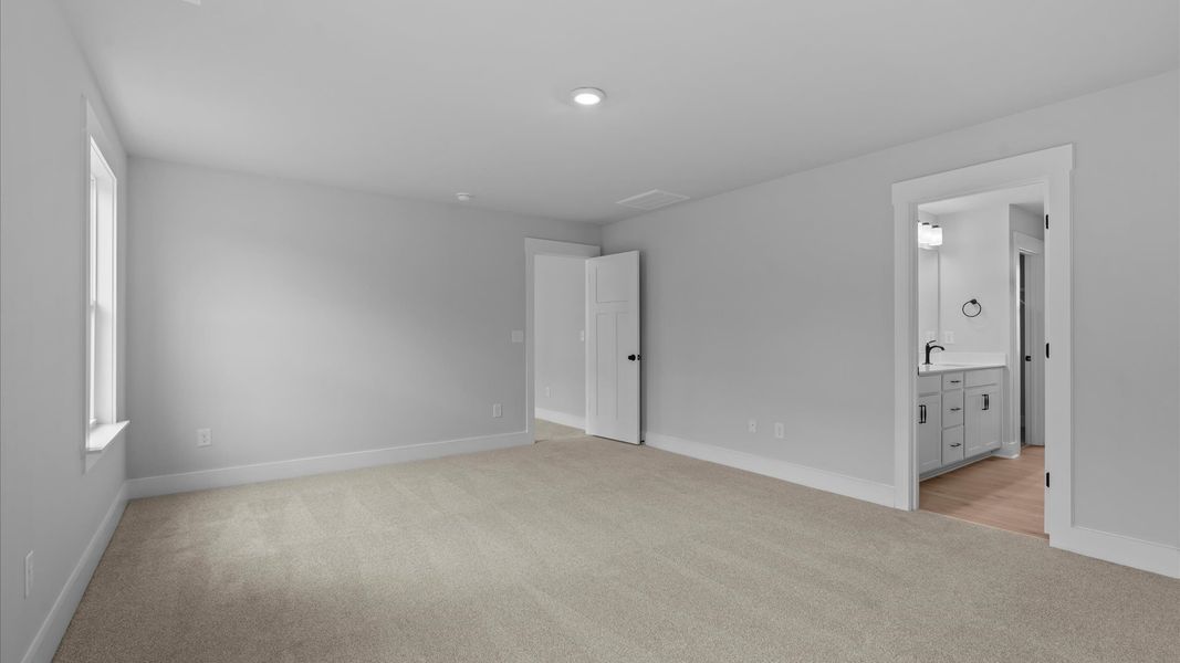 Vibrant natural light fills this exceptional primary suite with eye-catching details