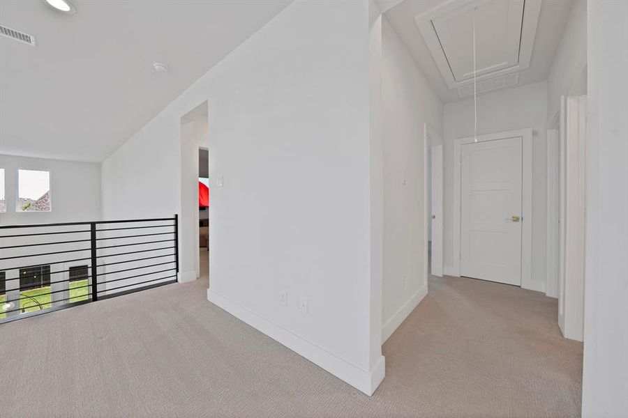 Second-story landing featuring plush carpeting, contemporary black metal railing, recessed lighting, and crisp white trim Second-story landing featuring plush carpeting, contemporary black metal railing, recessed lighting, and crisp white trim