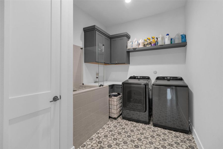 Spacious laundry room featuring a convenient pet wash area.